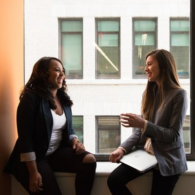 Two women in a casual office meeting